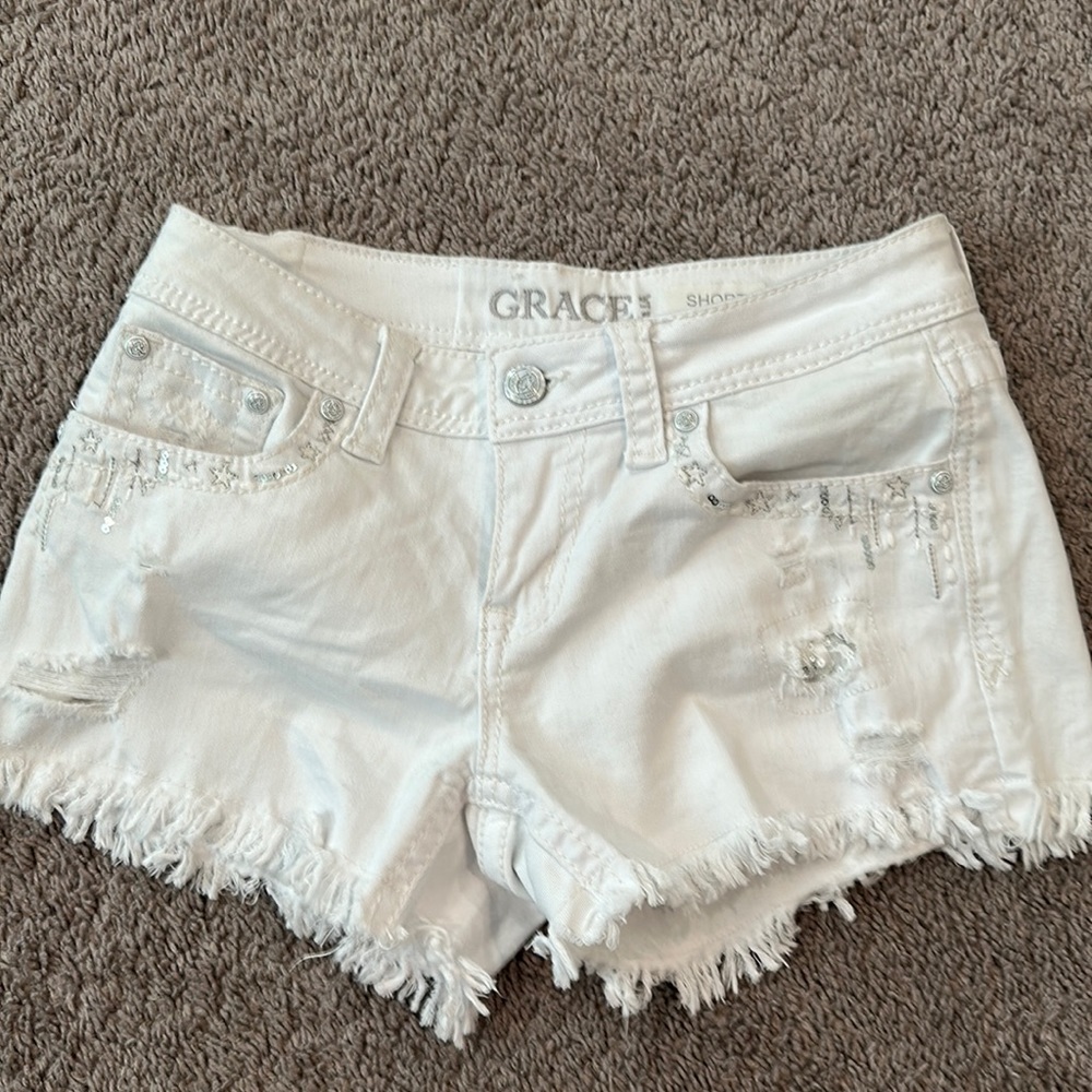 Adorable, white shorts with rhinestone stitching on the pockets